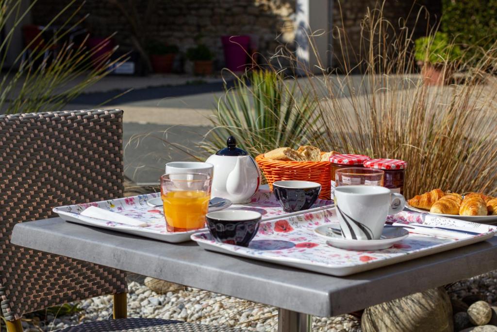 - une table avec un plateau de nourriture et de boissons dans l'établissement Hôtel Restaurant Le Commerce, à Saujon