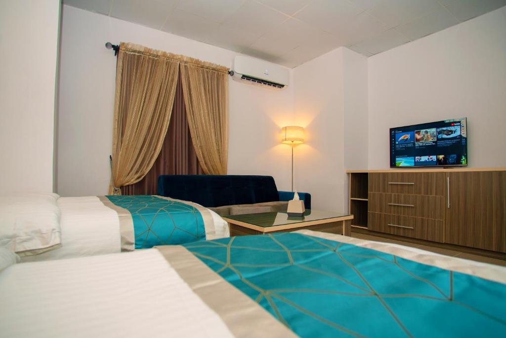 Ένα ή περισσότερα κρεβάτια σε δωμάτιο στο Riviera Suites