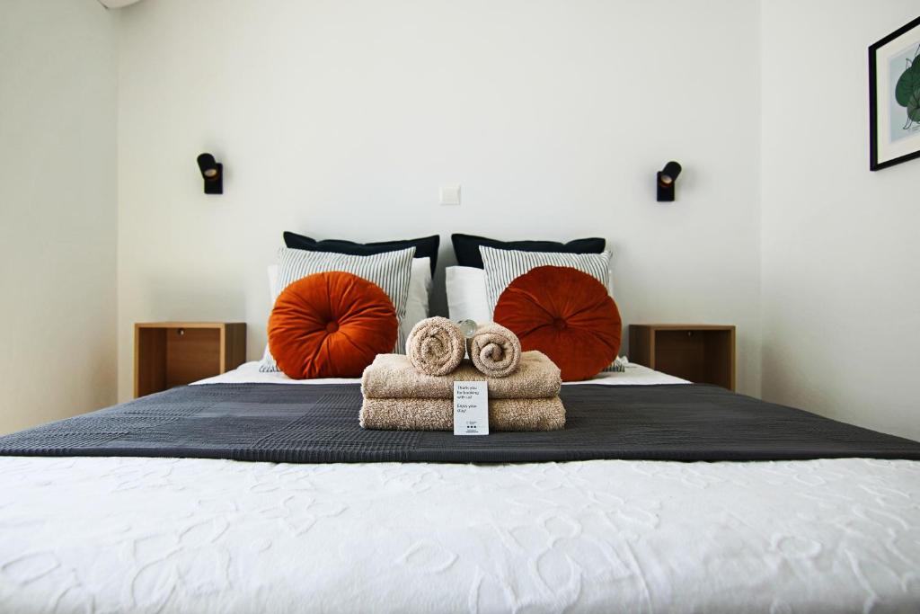 a bed with two towels and pillows on it at Phaedrus Living: Seaside Luxury Flat Lighthouse 62 in Paphos