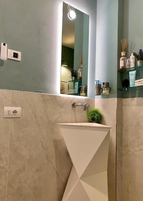 a bathroom with a sink and a mirror at Villa Luminosa in Torre del Lago Puccini