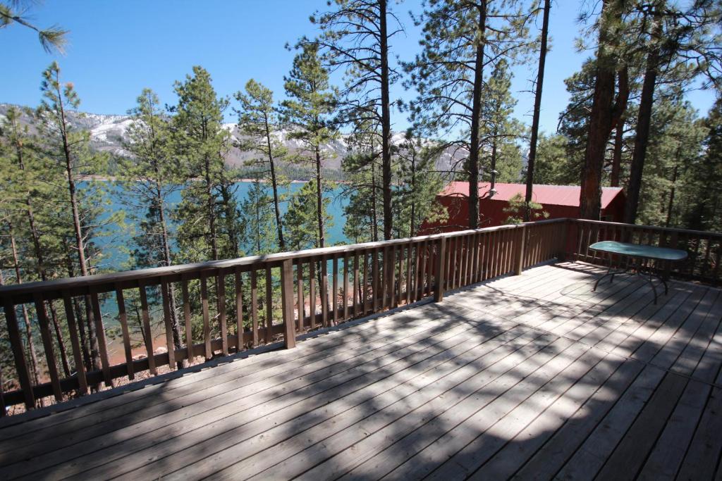 a deck with a bench and a view of the water at Paradise on the Lake in Vallecito
