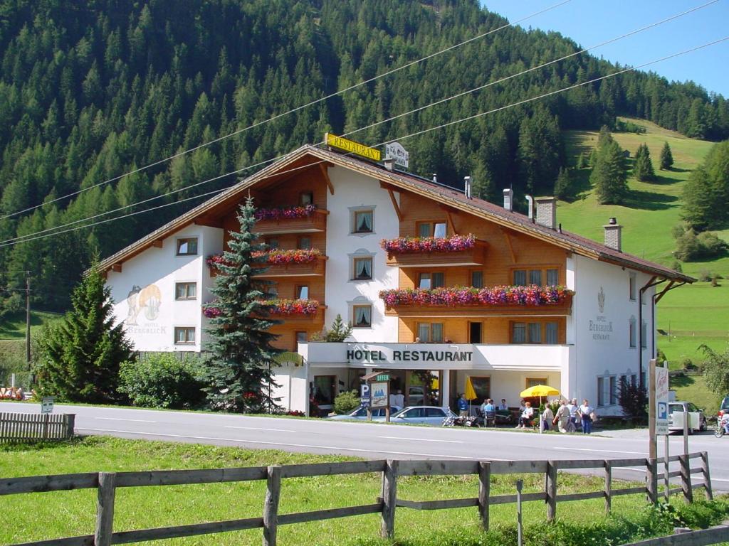 a large building with people standing outside of it at Hotel Bergblick in Nauders