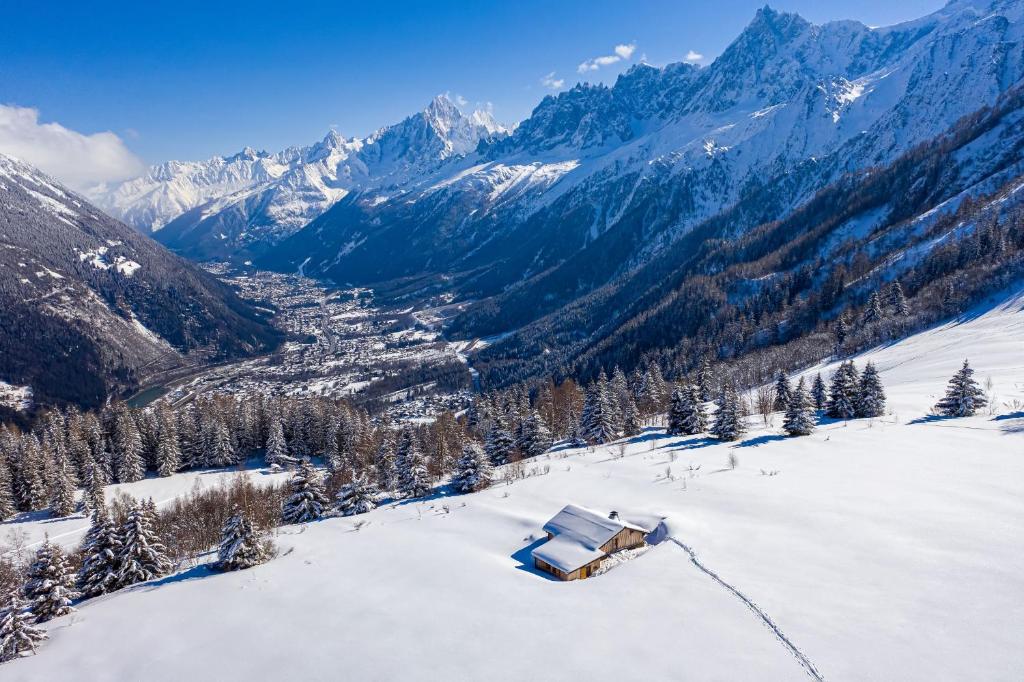 a snow covered mountain with a house on top of it at Chalet De Praz Dru in Les Houches