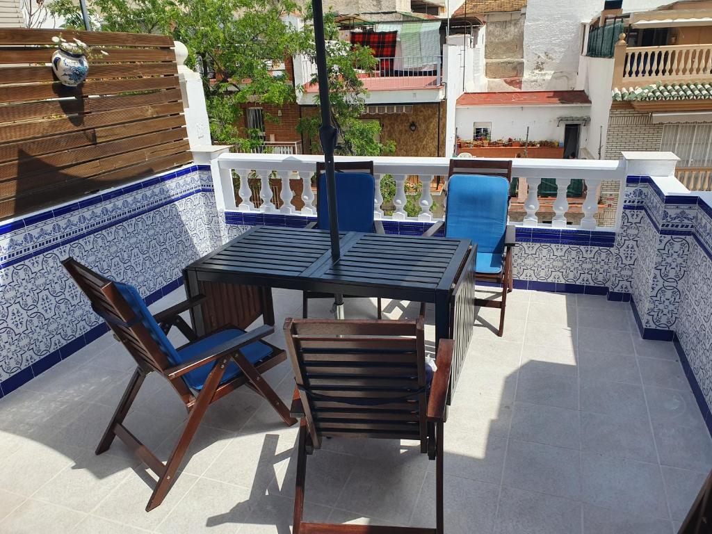 a black table and chairs on a patio at Private townhouse with roof terrace close to the beach in Málaga