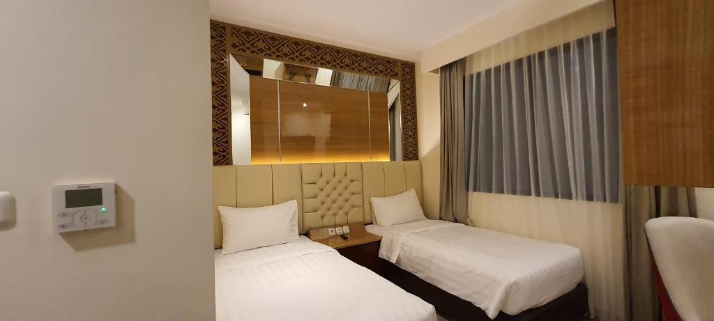 Postel nebo postele na pokoji v ubytování Hotel Daily Inn Bandung