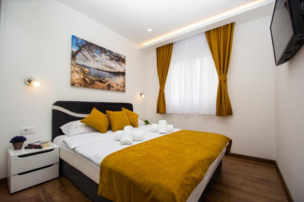 Postel nebo postele na pokoji v ubytování Milara Apartments