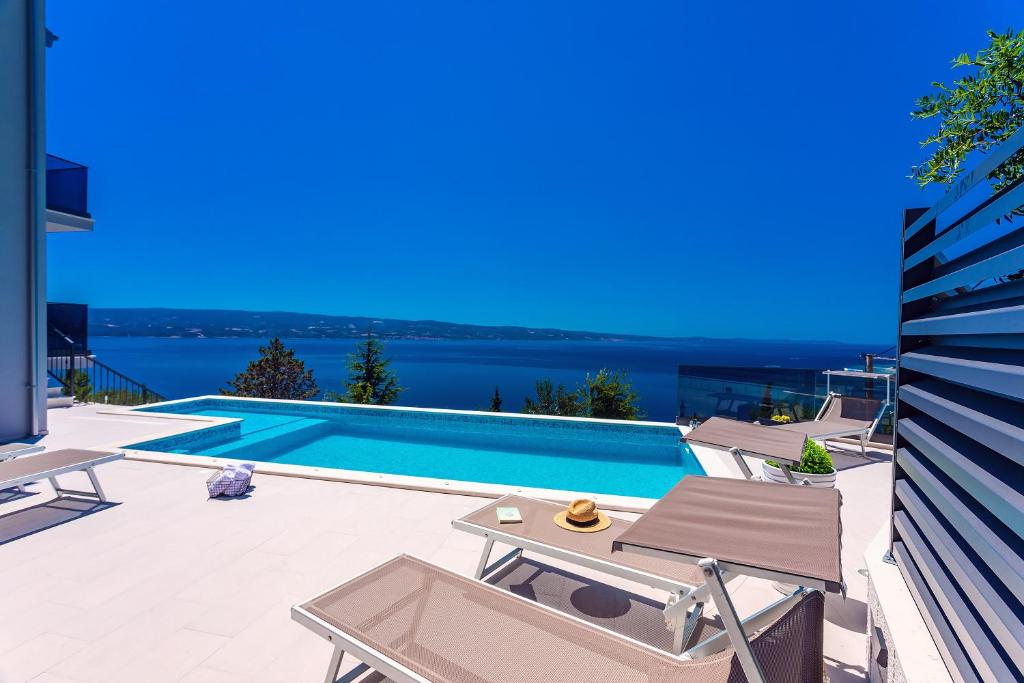 a swimming pool with a view of the water at Villa Belvedere with heated pool, billiards, Media room, sea views,10 pax in Omiš
