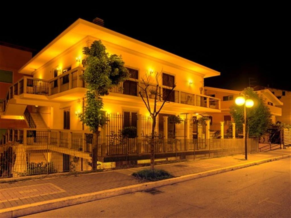 a white building with a street light in front of it at Villa Grace Tombolato in Montesilvano
