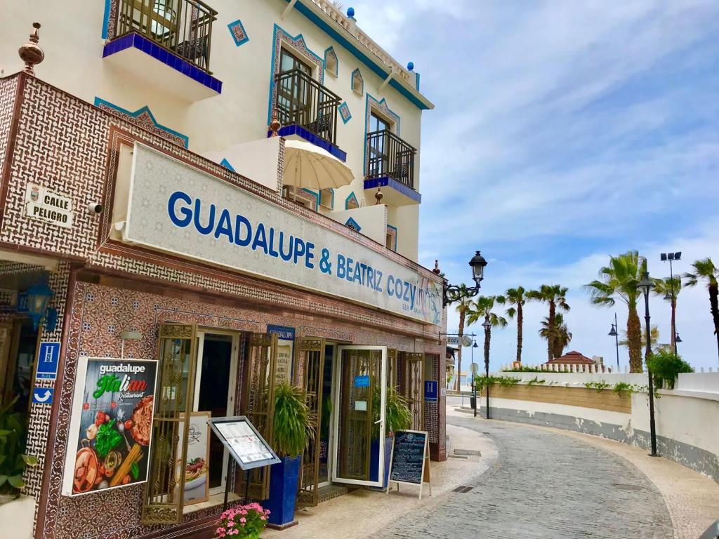 a building with a sign for a seafood restaurant at Guadalupe Cozy Inns in Torremolinos