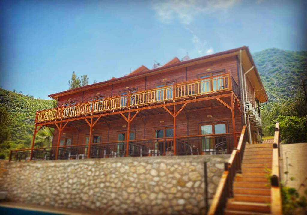 a large wooden house with stairs leading to it at 7 Green Adrasan in Adrasan