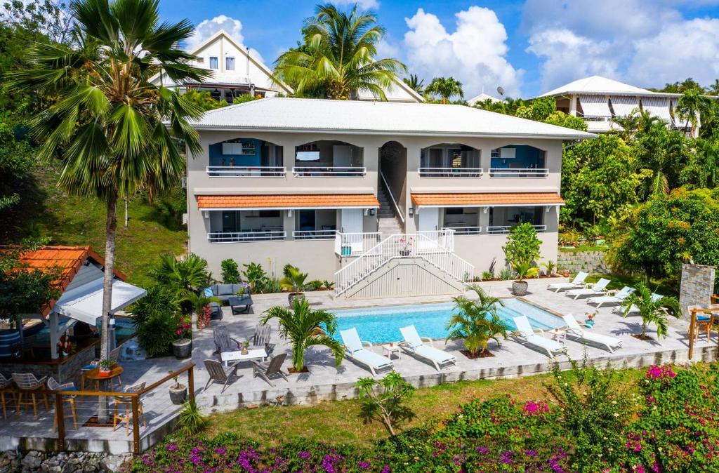 an aerial view of a house with a swimming pool at Kaz O'Rocher - Sea View Appartements in Le Diamant