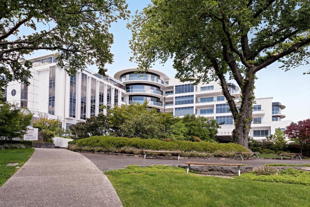 a building with a park in front of it at Mantra Charles Hotel in Launceston