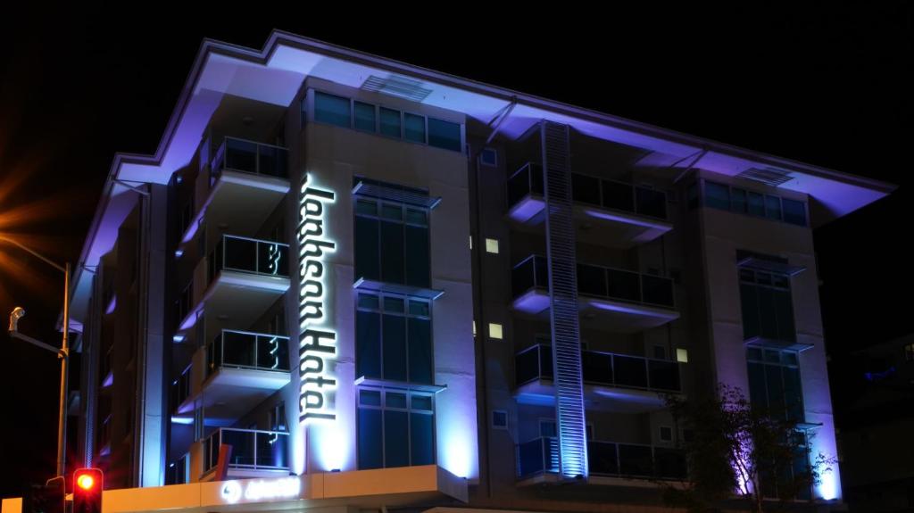 a building with a hotel sign lit up at night at Jephson Hotel & Apartments in Brisbane