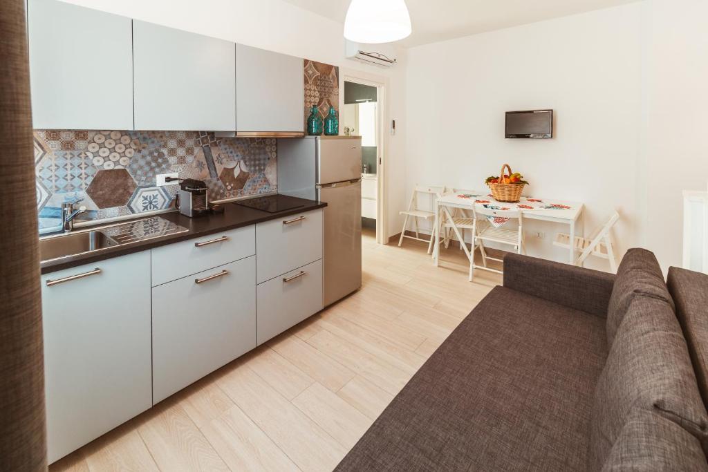 a kitchen and a living room with a couch at FeMa B&B - Housea in Polignano a Mare