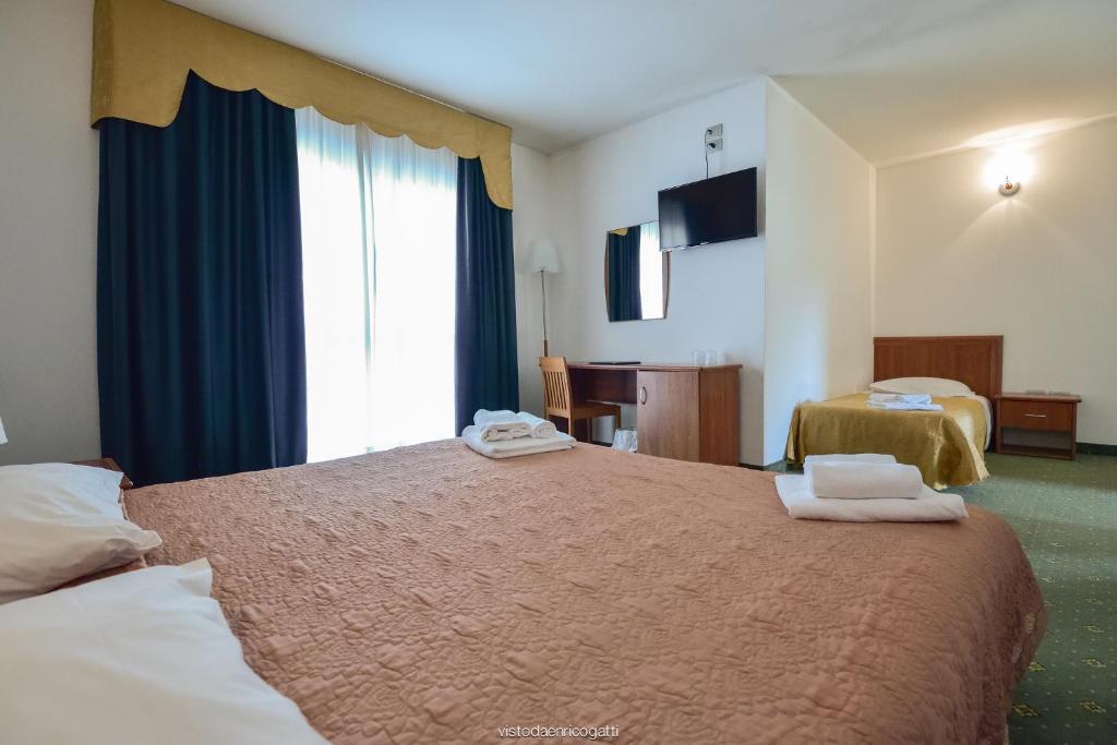 Postel nebo postele na pokoji v ubytování Standard Hotel Udine