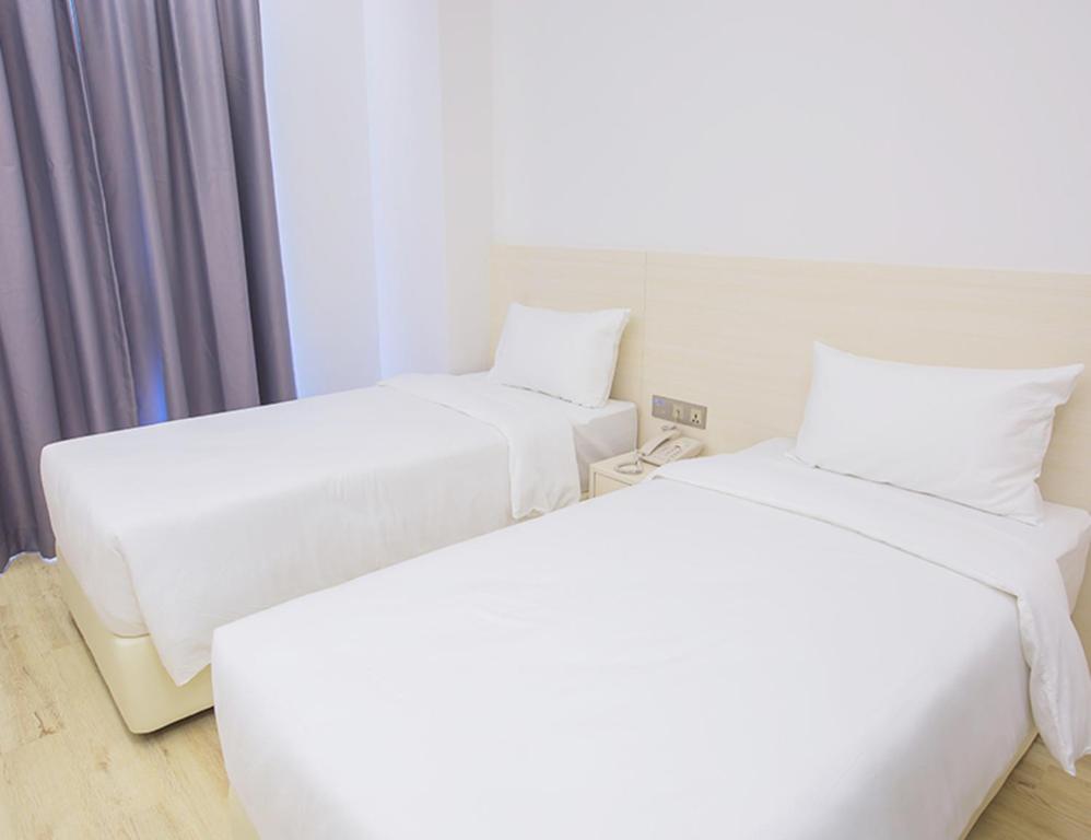Postel nebo postele na pokoji v ubytování Minimalist Hotel