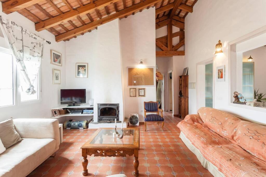 a living room with a couch and a coffee table at Chalet Piscina Roche in Cádiz