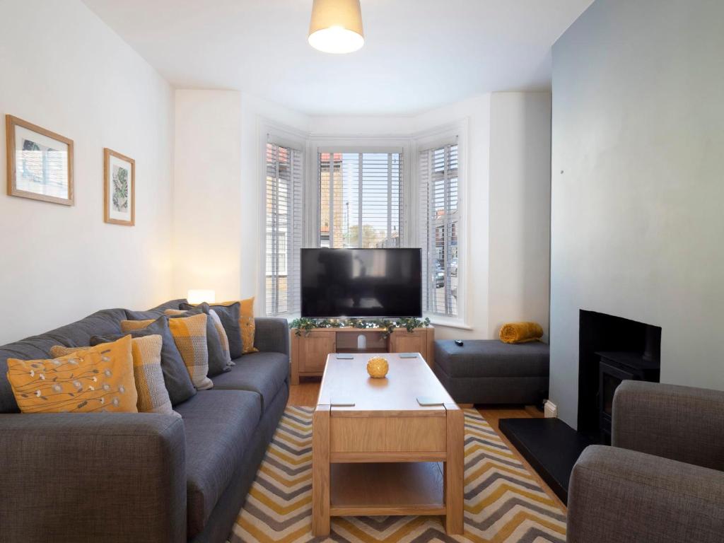 a living room with a couch and a tv at Host & Stay - Herbert Road in Ramsgate