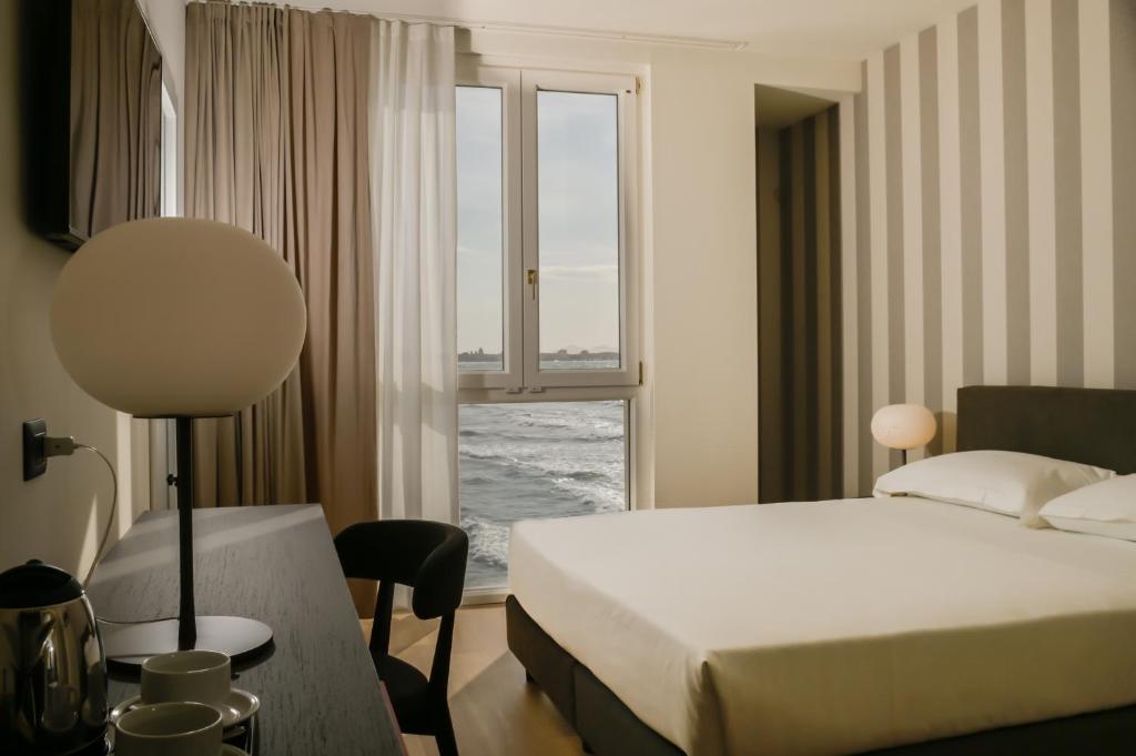 a hotel room with a bed and a window at Hotel Punta Tipa in Trapani
