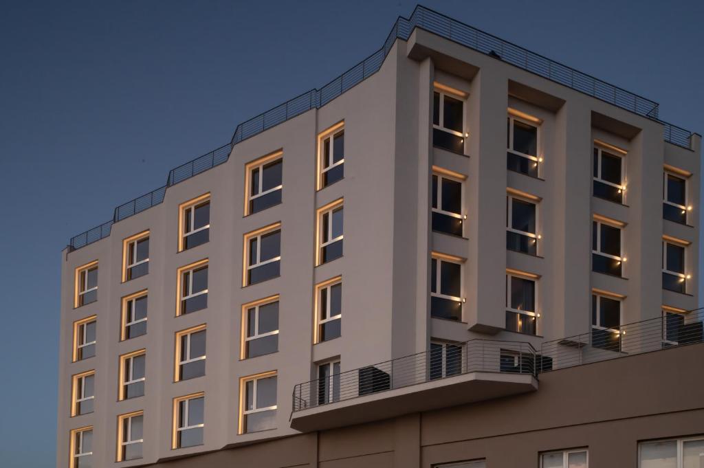 an apartment building with lights on at Hotel Punta Tipa in Trapani
