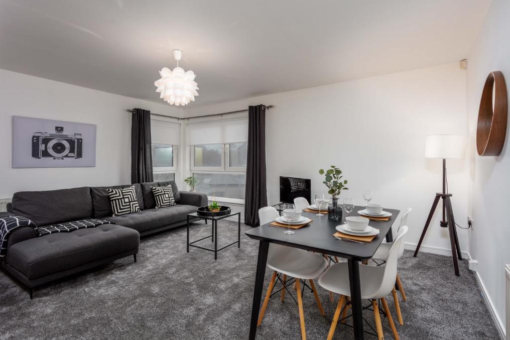 a living room with a couch and a table at Walker Suite No73 - Donnini Apartments in Kilmarnock