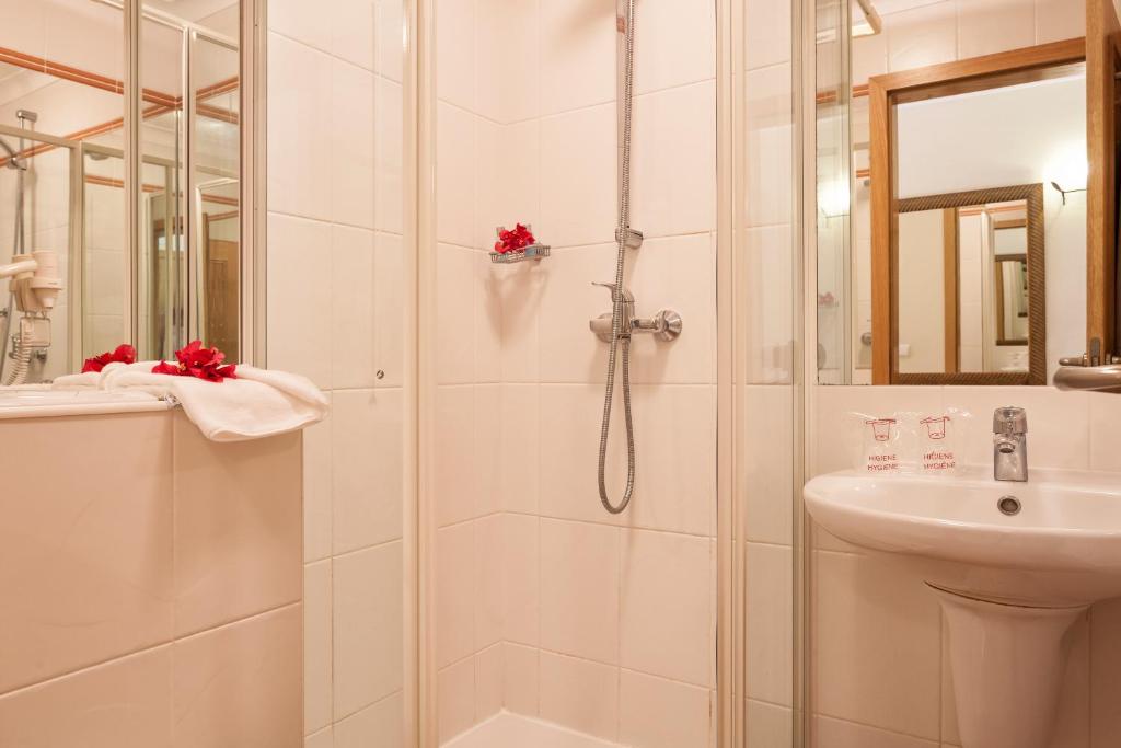 a bathroom with a shower and a sink at Pestana Palm Gardens in Carvoeiro