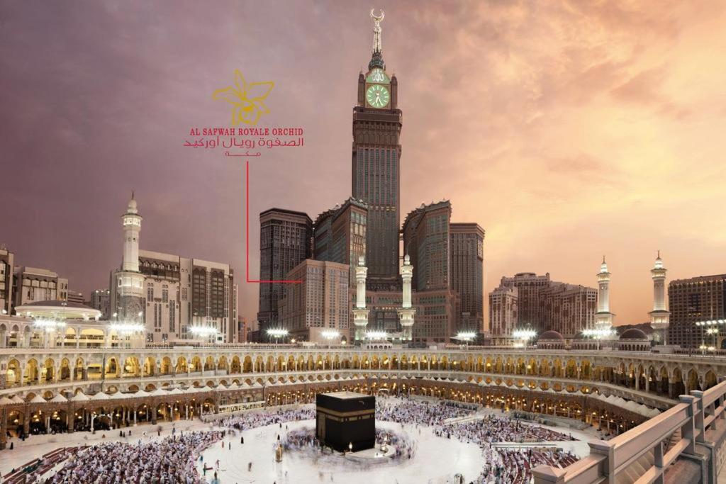 a large crowd of people in a city with a clock tower at Al Safwah Orchid Hotel in Makkah