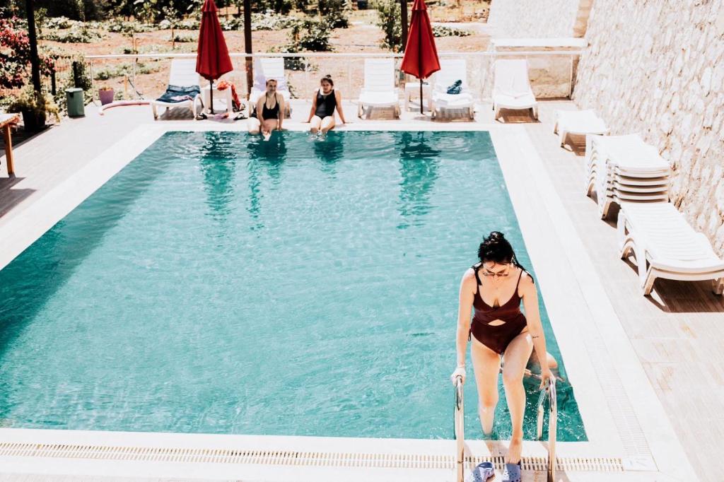 a woman in a bikini sitting in a swimming pool at 7 Green Adrasan in Adrasan