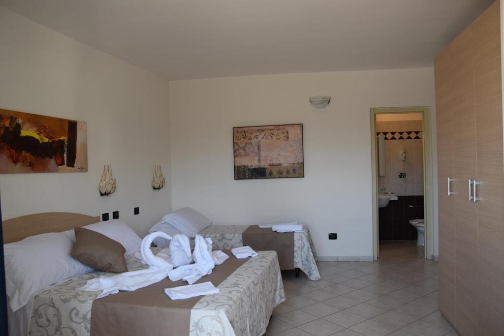 Postel nebo postele na pokoji v ubytování Hotel Profumo Di Mare