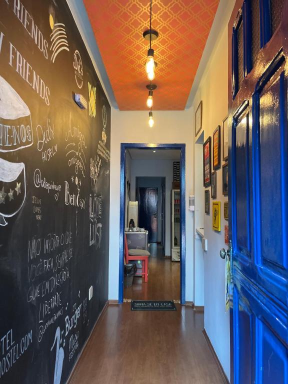 a hallway with a chalkboard wall in a restaurant at Did's Hostel São Paulo in Sao Paulo