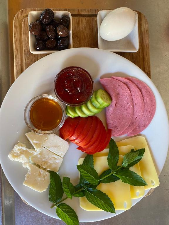 a plate of food with different types of cheese and meats at 7 Green Adrasan in Adrasan