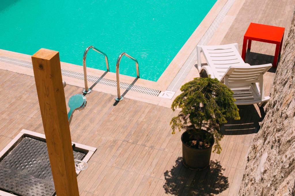 a pool with two chairs and a plant next to it at 7 Green Adrasan in Adrasan