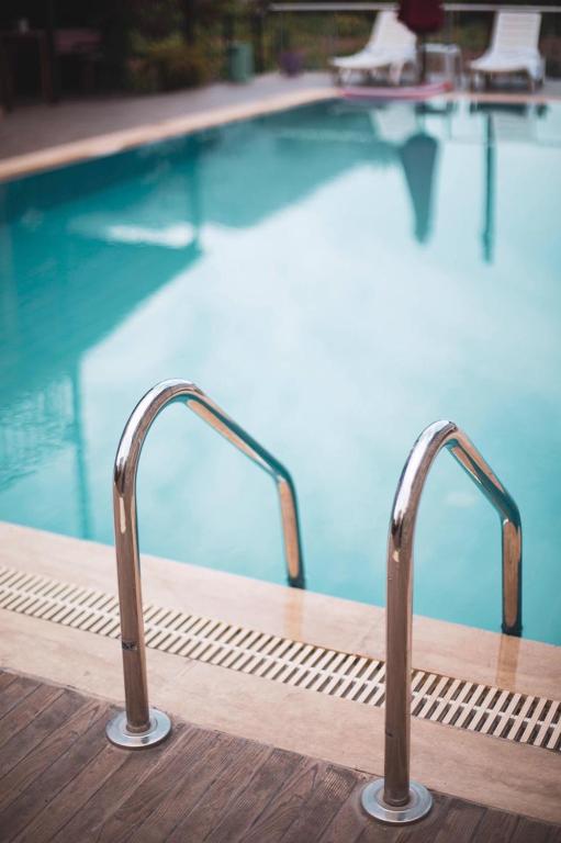 a swimming pool with two metal hand rails next to it at 7 Green Adrasan in Adrasan