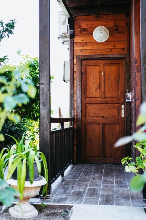 a wooden front door of a house with a plant at 7 Green Adrasan in Adrasan