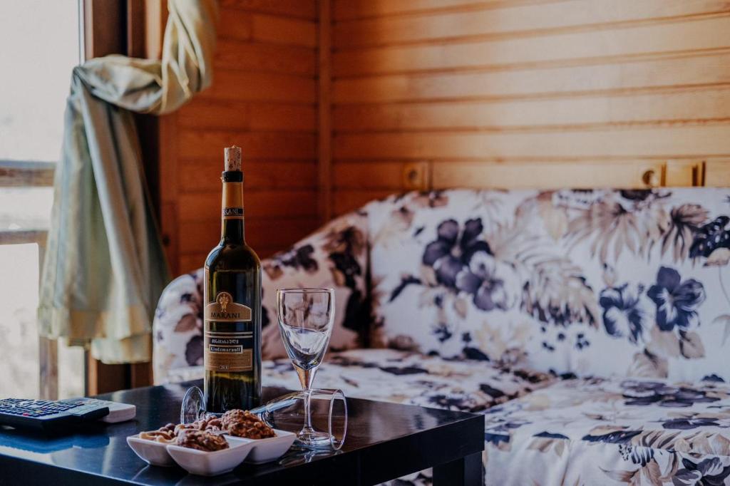 a bottle of wine and glasses on a table with a couch at 7 Green Adrasan in Adrasan