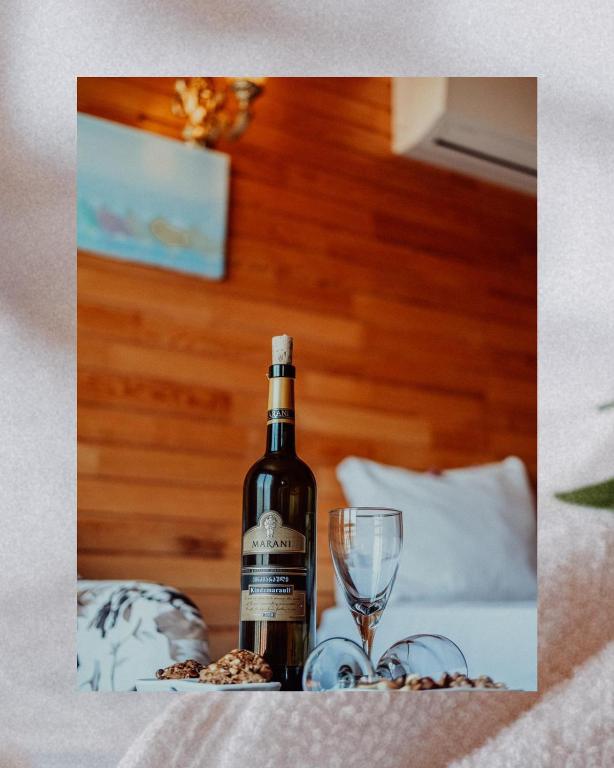 a bottle of wine and a glass on a table at 7 Green Adrasan in Adrasan