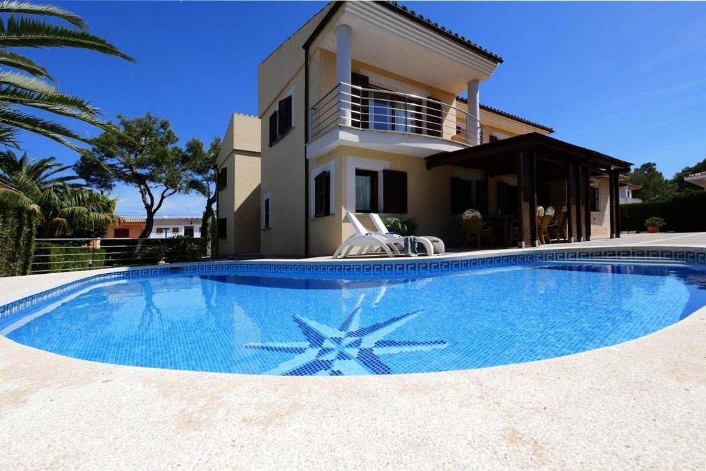 a large swimming pool in front of a house at Villa Northern Star in Alcudia