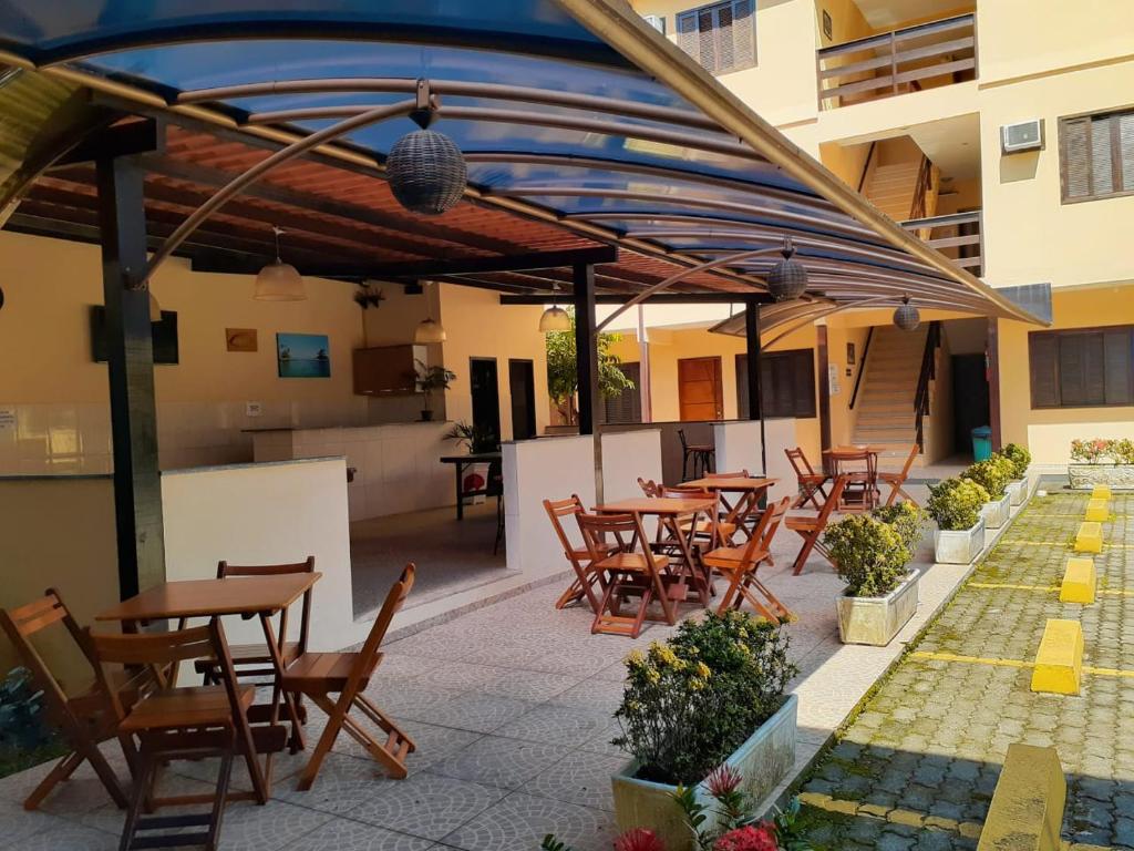 a group of tables and chairs on a patio at Pousada do Cardoso in Angra dos Reis