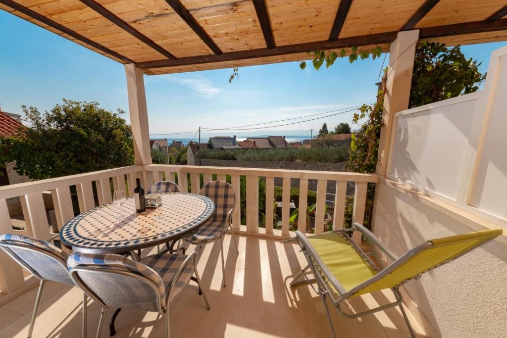 a patio with a table and chairs on a balcony at Bungalows Ivan (3757) in Bol