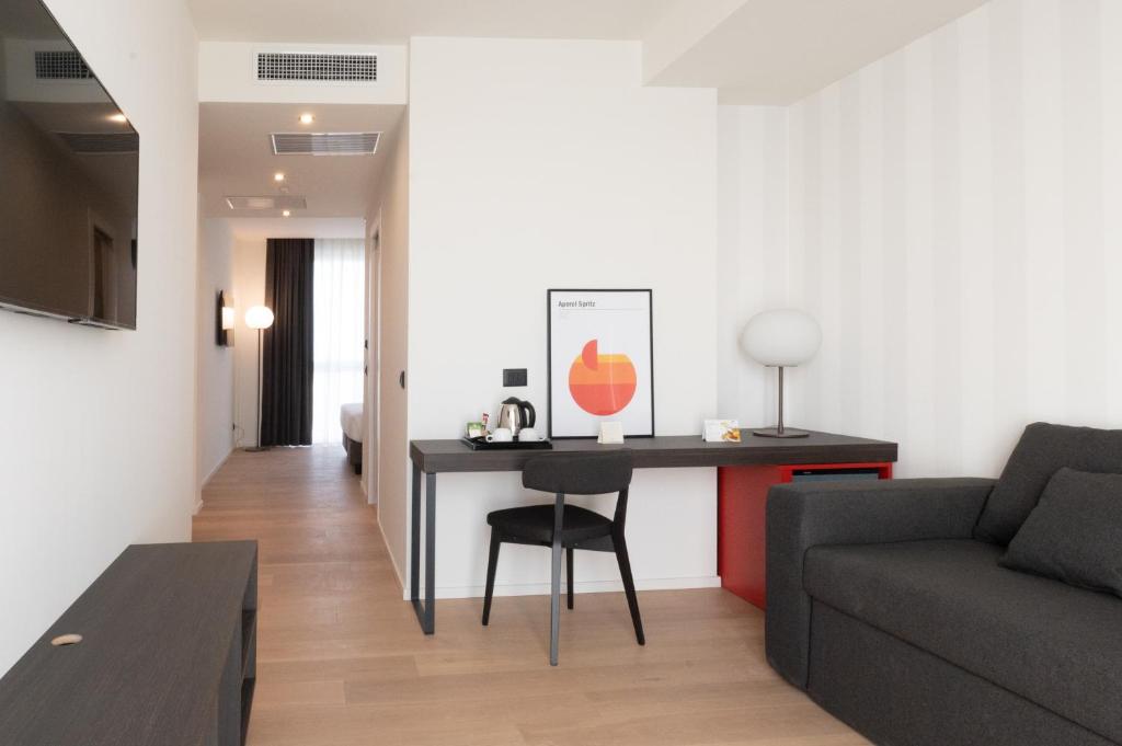 a living room with a table and a couch at Hotel Punta Tipa in Trapani