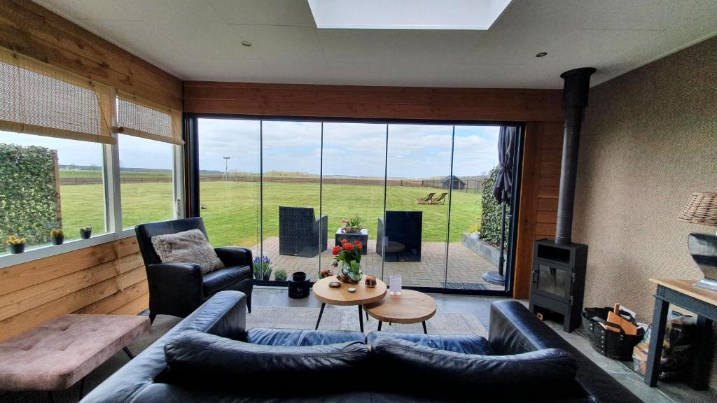 a living room with a couch and a table at B&B Hertenhoef, Fluitenberg (Hoogeveen) in Fluitenberg