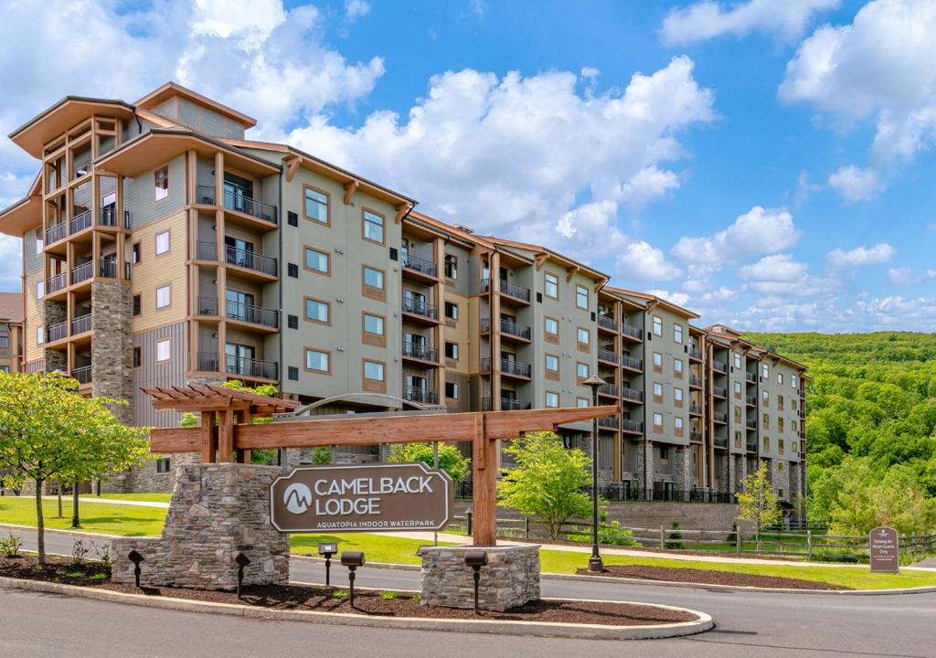 a sign in front of a large apartment building at Camelback Resort in Tannersville