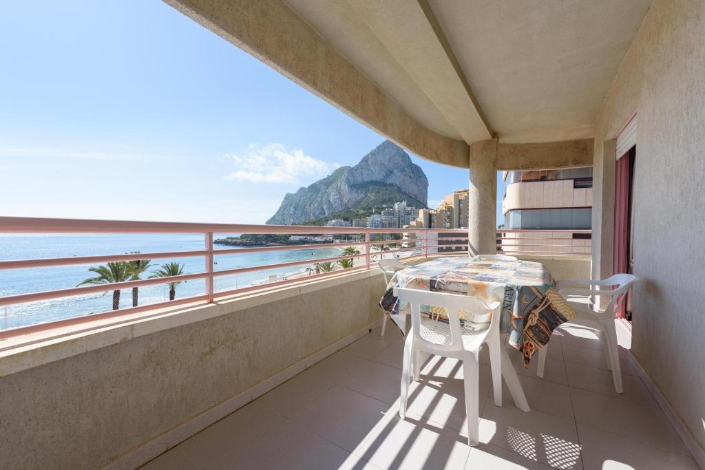 a balcony with a table and a view of the ocean at Apartamentos Nuevo México C 142 in Calpe