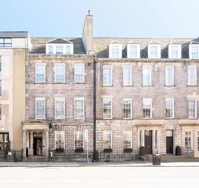 a large brick building with white windows at Native Edinburgh in Edinburgh