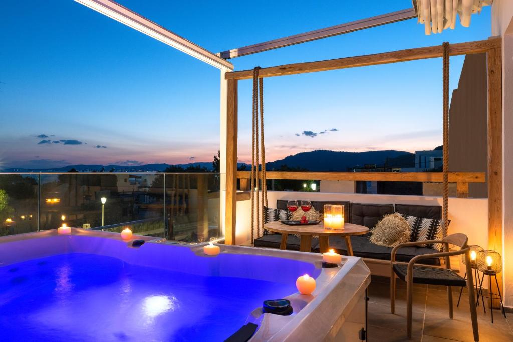 una vasca idromassaggio su un balcone con vista sulla città di Pefkos Allure Luxury Suites with Jacuzzi in the heart of Pefkos!!! a Pefki Rhodes