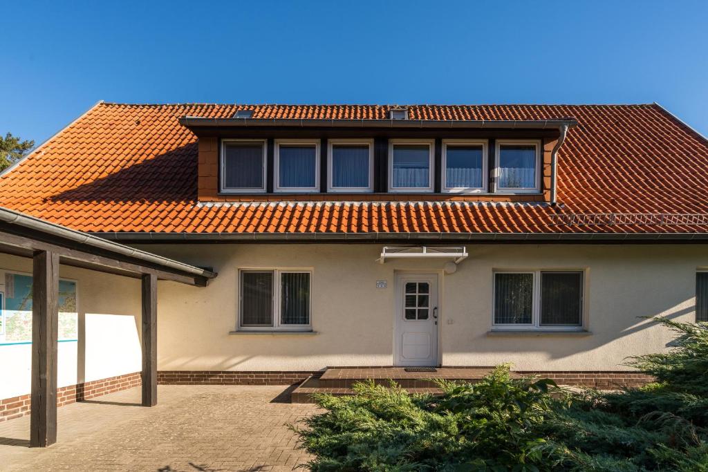 a house with an orange tiled roof at Ferienwohnung 4, Waldesruh Dierhagen in Dierhagen