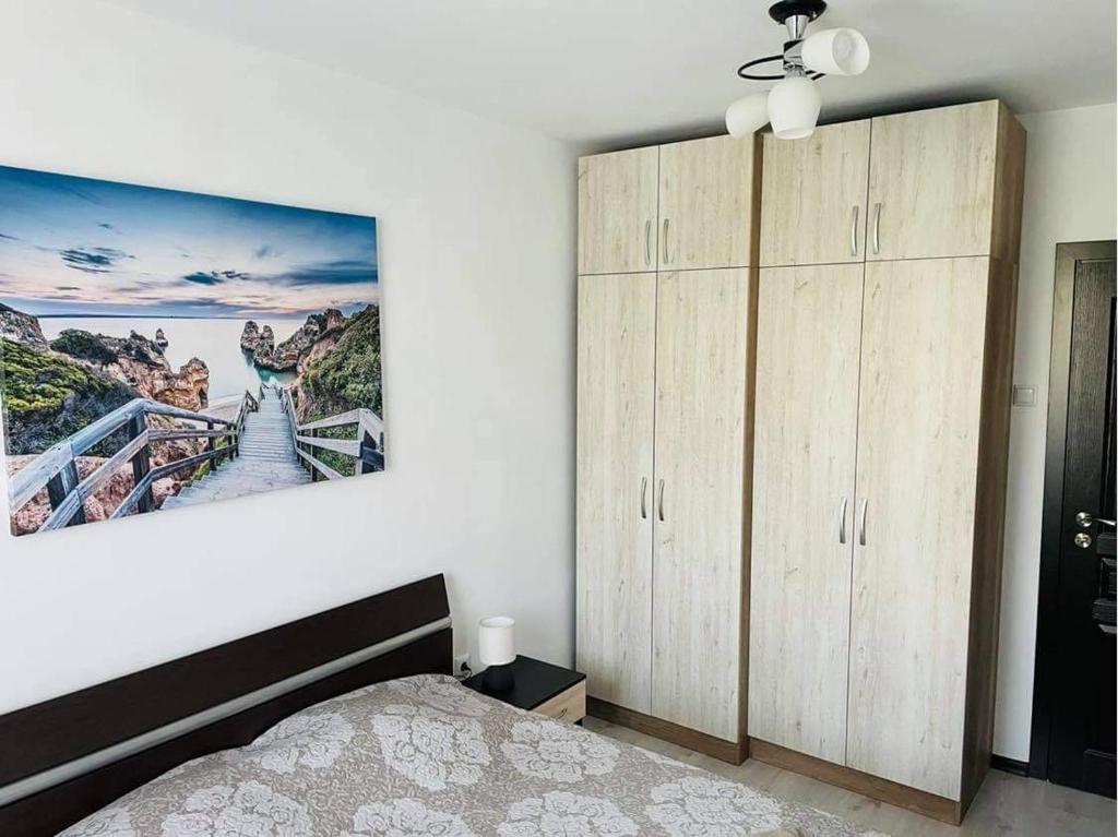 a bedroom with a bed and a large painting on the wall at Welcome home in Stara Zagora