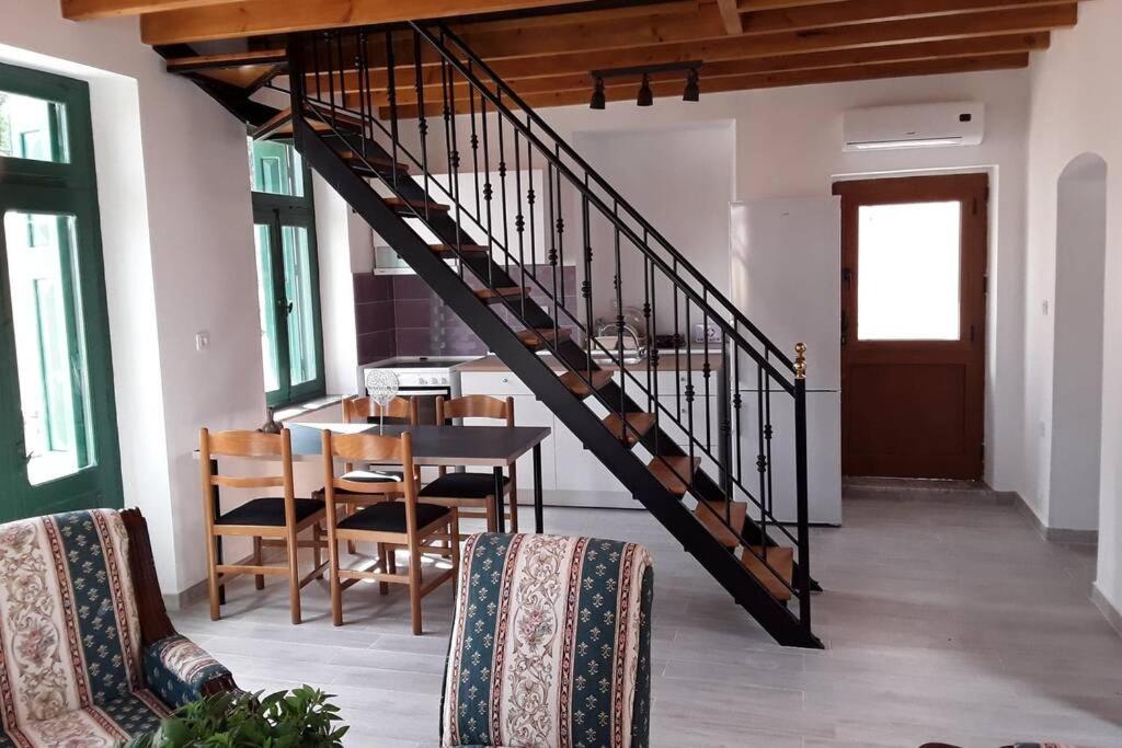 a staircase in a living room with a table and chairs at Giorgina's House in Symi