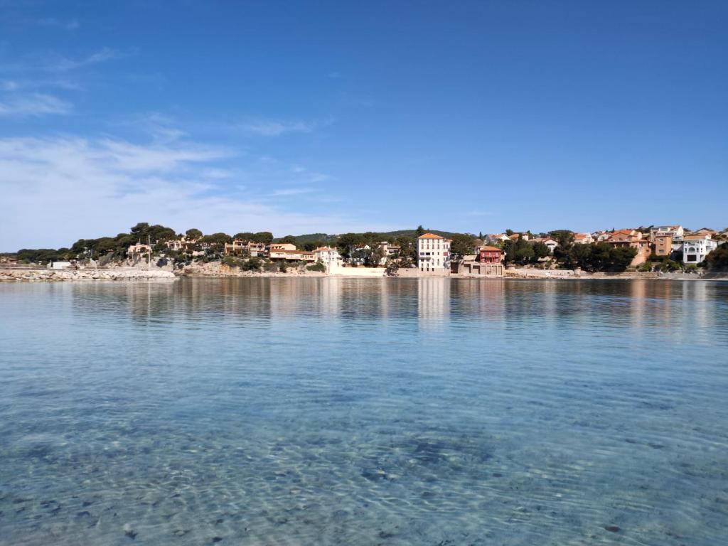 a view of a large body of water with houses at Joli studio les pieds dans l eau avec place de Parking gratuite in Bandol