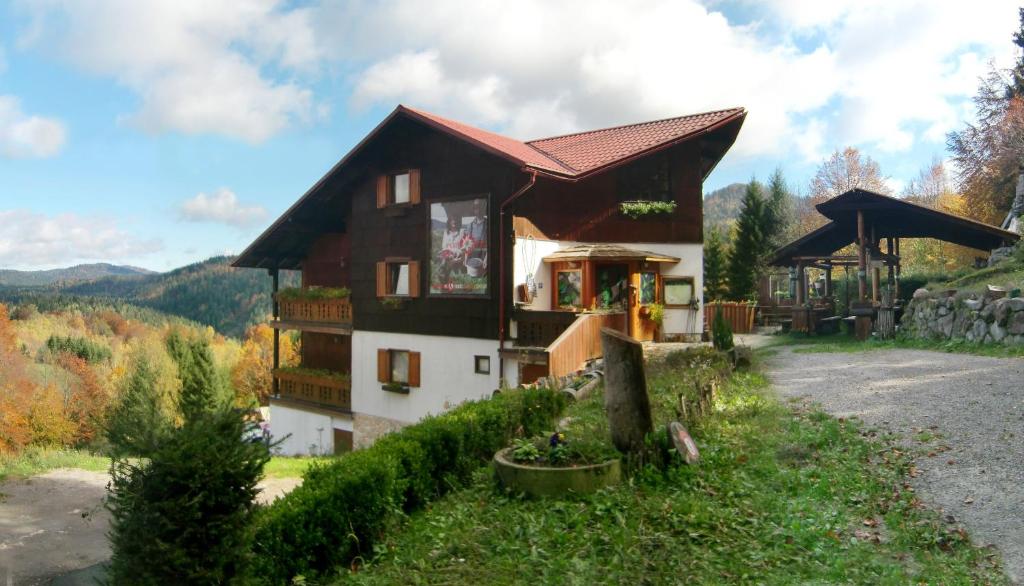 a house in the middle of a road at Kod Korita Rooms in Crni Lug